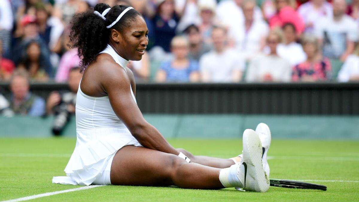 Serena Williams reacts after slipping and falling to the court during her match against Svetlana Kuznetsova on Monday at Wimbledon.