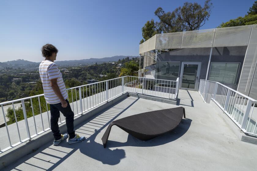 Los Angeles, CA - September 25: Aleksandar Jovanovic, a Airbnb landlord, looks out over a patio space on top his guesthouse, located on the property of his Los Angeles home. His tenant, Elizabeth Hirschhorn, not pictured, is still living in his guesthouse listed on Airbnb after the lease ended nearly two years ago without paying rent. Photo taken in Los Angeles Monday, Sept. 25, 2023. (Allen J. Schaben / Los Angeles Times)