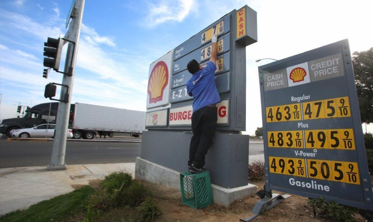 In this Oct. 5, 2012, photo, Luis Cuevas changes the gas prices at the Shell station off California State Route 99. Stunning numbers like these have more Americans shopping for bargains and joining brand loyalty programs to get a break on gasoline prices.