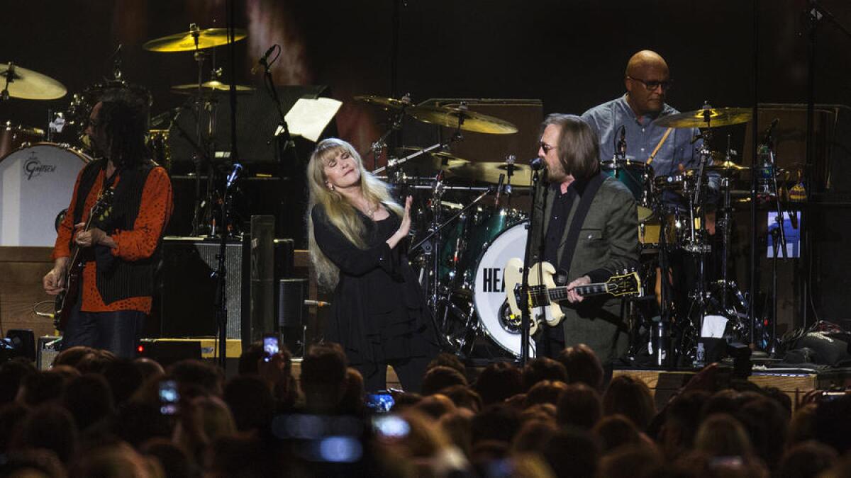 Tom Petty sings a duet with Stevie Nicks at the Los Angeles Convention Center on Friday.