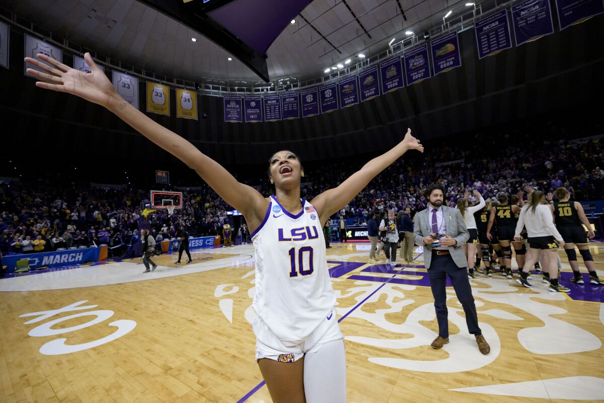 LSU forward Angel Reese (10) waves to the crowd after LSU defeated Michigan in a second-round college basketball game in the women's NCAA Tournament in Baton Rouge, La., Sunday, March 19, 2023. (AP Photo/Matthew Hinton)