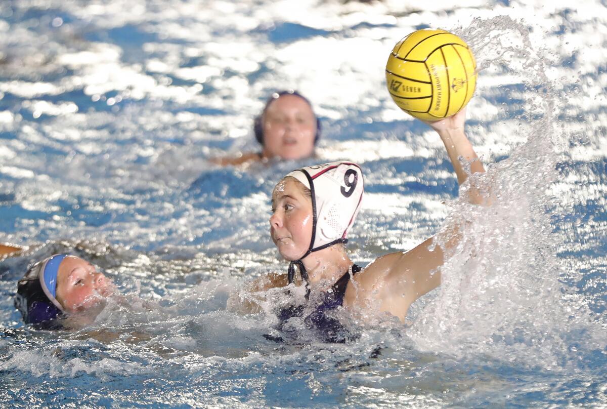 CdM's Didi Evans (9) takes a shot for a score during the annual Battle of the Bay girls' water polo match on Thursday.