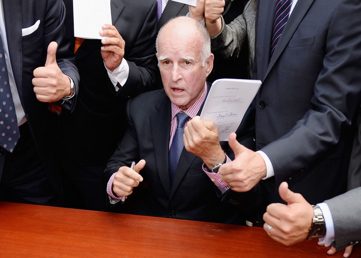 Gov. Jerry Brown approved a package of 18 business-friendly bills. Above, the governor at a previous signing event in Los Angeles.