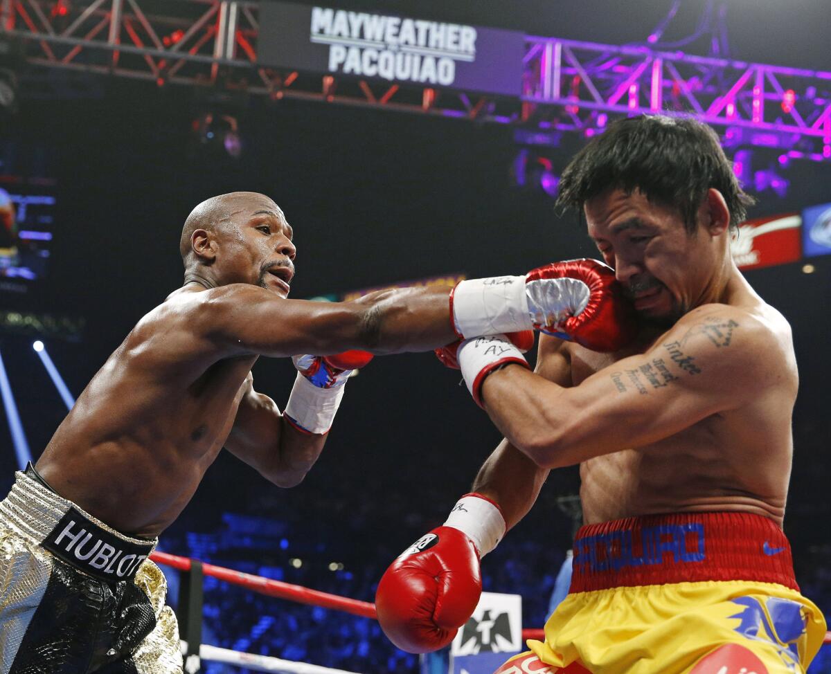 Floyd Mayweather Jr. connects with a right to the head of Manny Pacquiao during their welterweight title fight on May 2, 2015 in Las Vegas. A rematch between the now-retired Mayweather and a revitalized Pacquiao might be the crowd pleaser fight fans hoped for the first time.