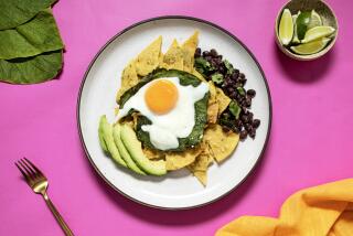 EL SEGUNDO, CA - THURSDAY, MAY 18, 2023 - Chilaquiles Verdes with Hoja Santa Eggs and Garlicky Beans with Parsley, photographed in the LA Times Kitchen on May 18, 2023. (Ricardo DeAratanha/Los Angeles Times)