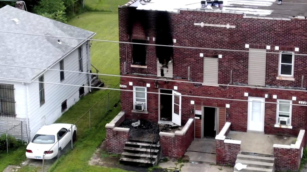 This screen shot from KMOV-TV shows damage to an East St. Louis, Ill. apartment from a fire on Friday, Aug. 6, 2021. Officials say five children all younger than 10 who were left home without an adult died in a fire at an apartment building in southwestern Illinois. (KMOV-TV via AP)