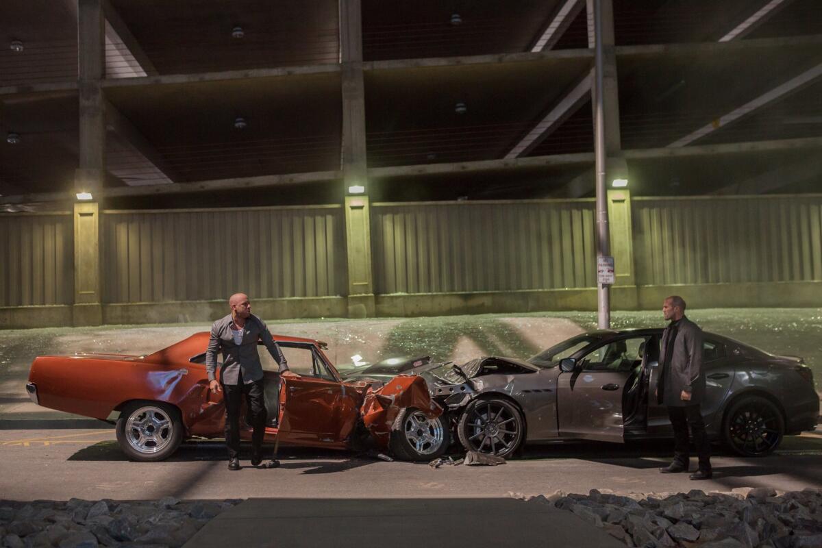 Vin Diesel, left, as Dom Toretto, and Jason Statham, as Deckard Shaw, in a scene from "Furious 7." The high-octane thriller maintained its pace in its third week, speeding away with $29 million at North American theaters.