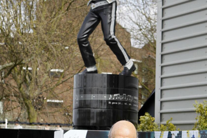 Fulham owner Mohamed Al Fayed is all smiles after unveiling a statue of Michael Jackson at the Craven Cottage Stadium grounds in London.