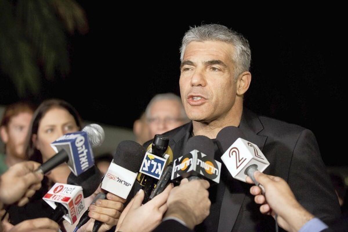 Yair Lapid speaks to journalists outside his house in Tel Aviv after his party's unexpectedly strong showing in Israeli parliamentary elections.