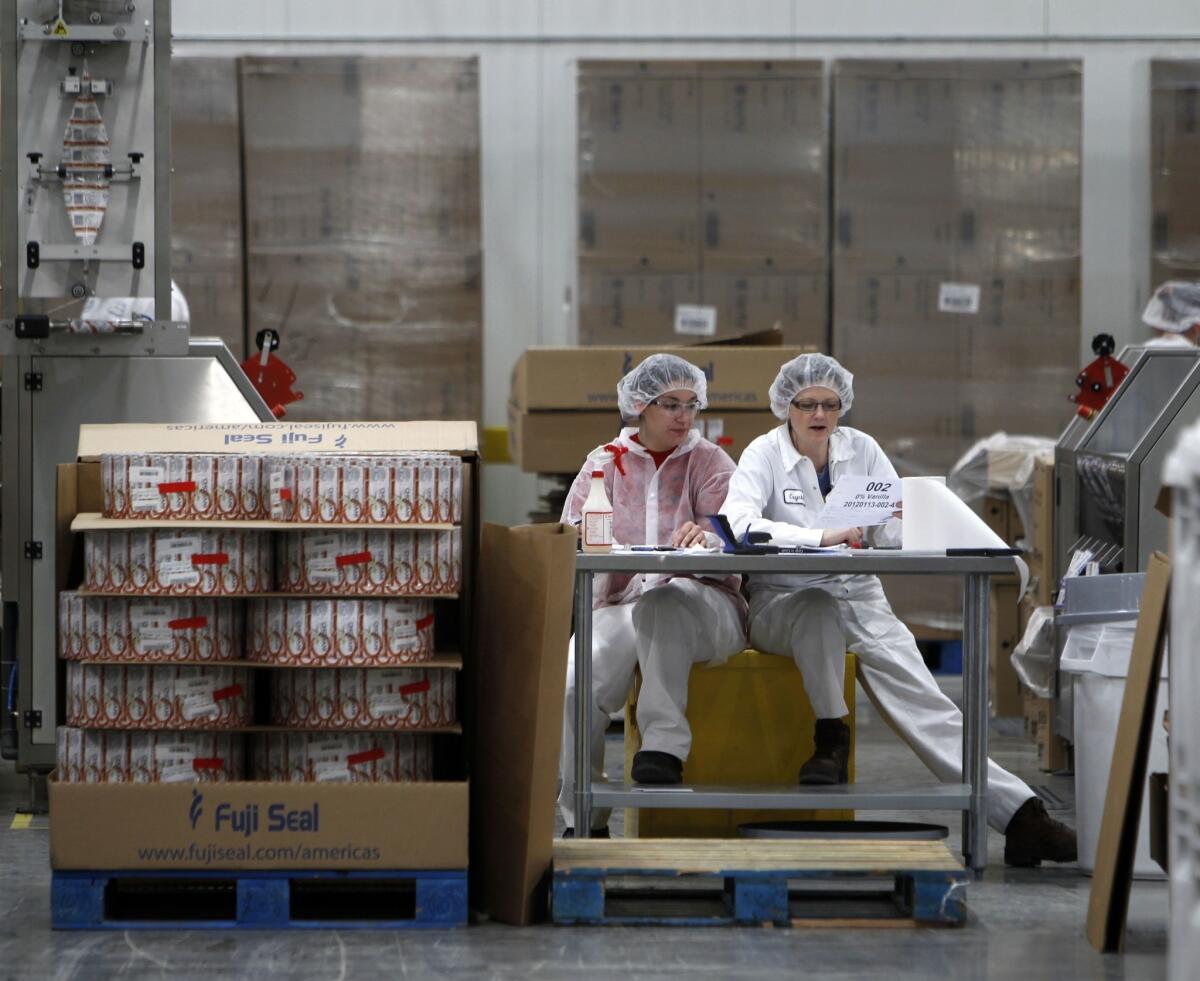 After Russian authorities blocked a shipment of Chobani Greek yogurt intended for American Olympics athletes competing in Sochi, the comapny on Thursday said it is donating the 5,000 cups of yogurt to New York and New Jersey food banks. Above, two workers at a Chobani plant in South Edmeston, N.Y.