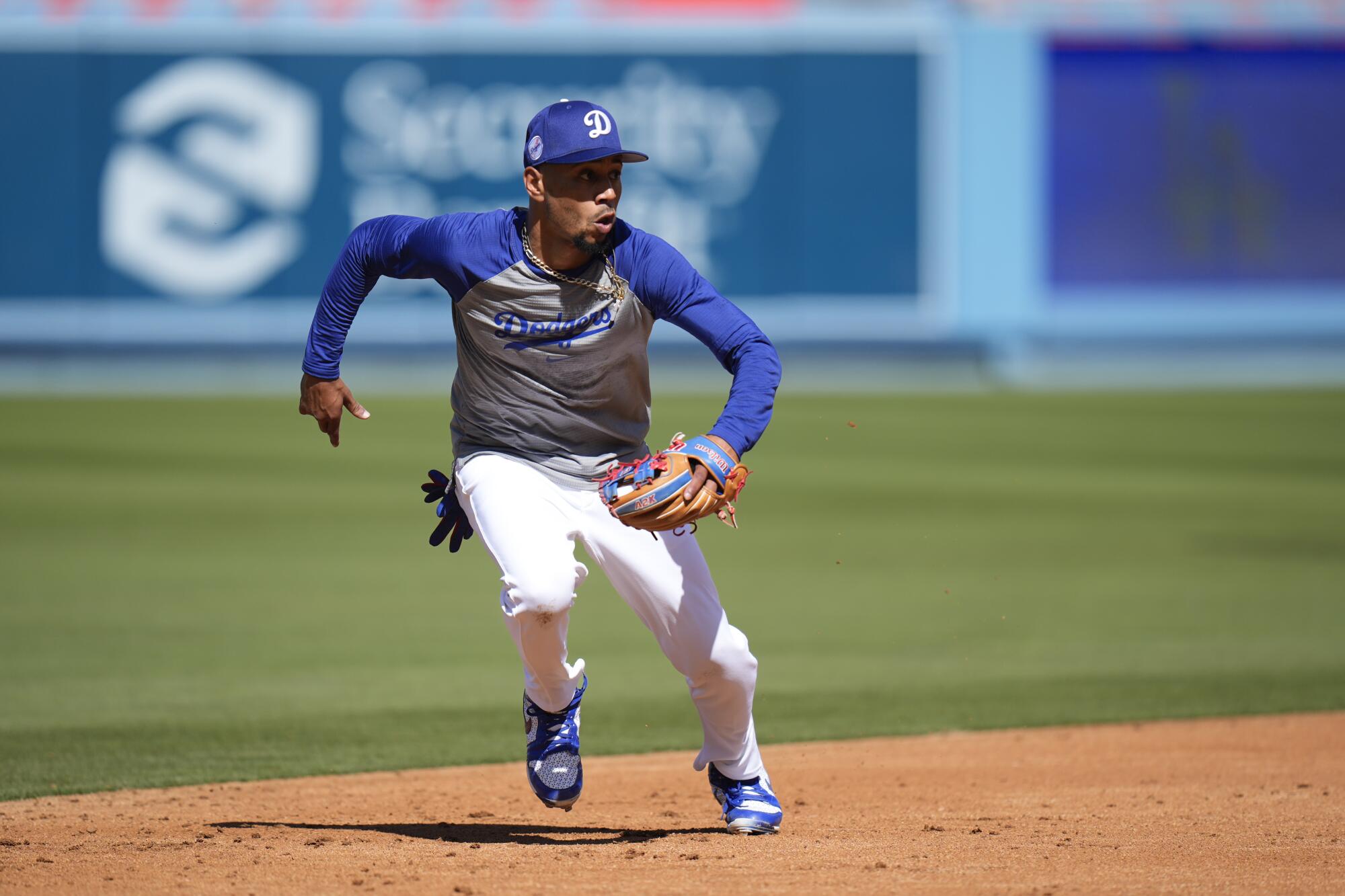 Dodgers shortstop Mookie Betts chases a ground ball during practice before the team played the Cardinals on Friday.