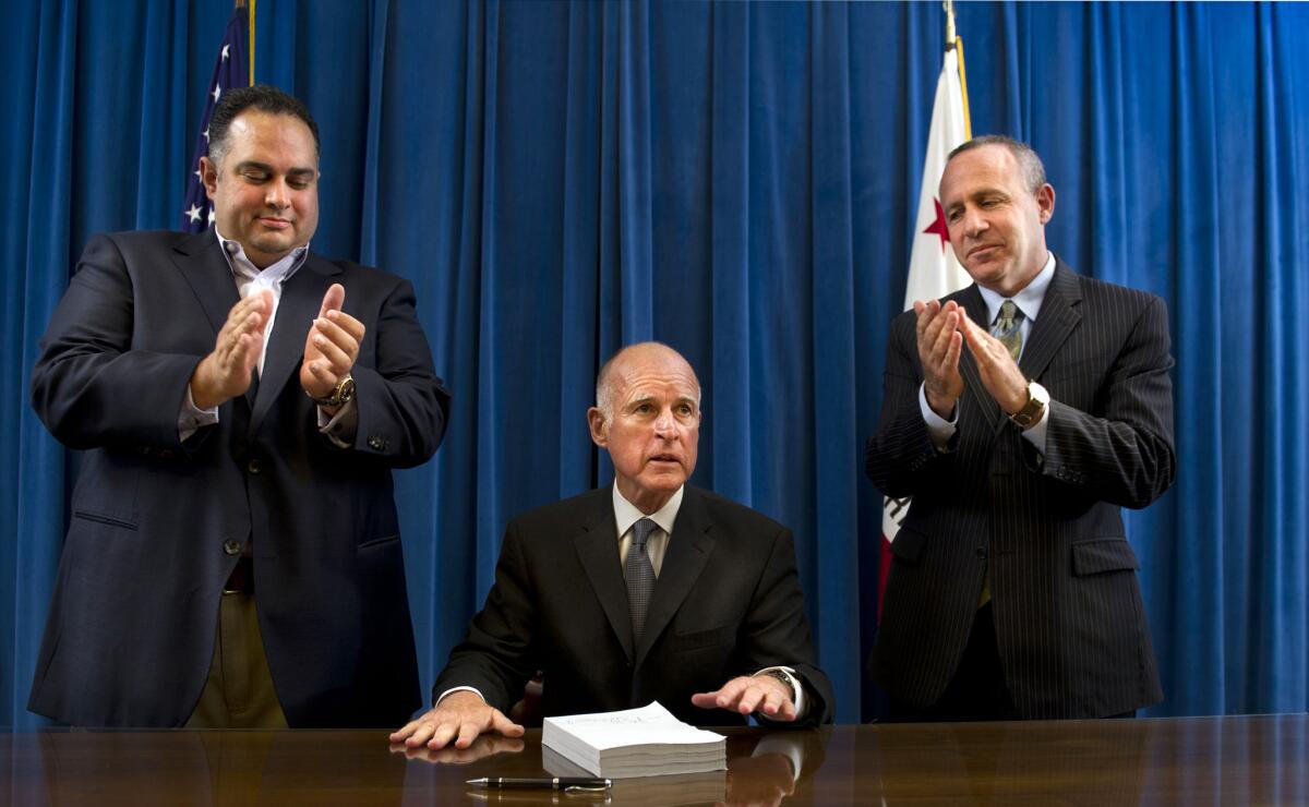 California's departing Assembly Speaker John A. Perez, left, and Senate President Pro Tem Darrell Steinberg, right, are seen in 2011 with Gov. Jerry Brown.