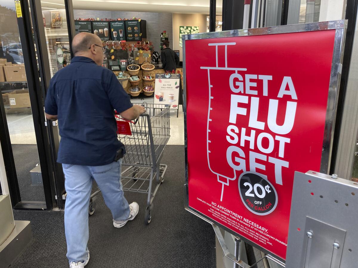 A sign outside a grocery store urges shoppers to get a flu shot. 
