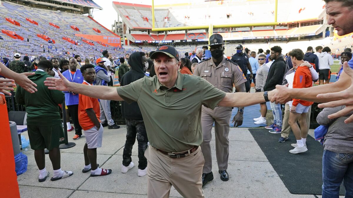 Florida head coach Dan Mullen greets fans as he leaves the field after defeating Samford in an NCAA college football game, Saturday, Nov. 13, 2021, in Gainesville, Fla. (AP Photo/John Raoux)