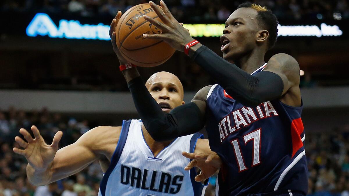 Atlanta's Dennis Schroder, right, puts up a shot in front of Dallas' Richard Jefferson during the Hawks' 105-102 win Monday.