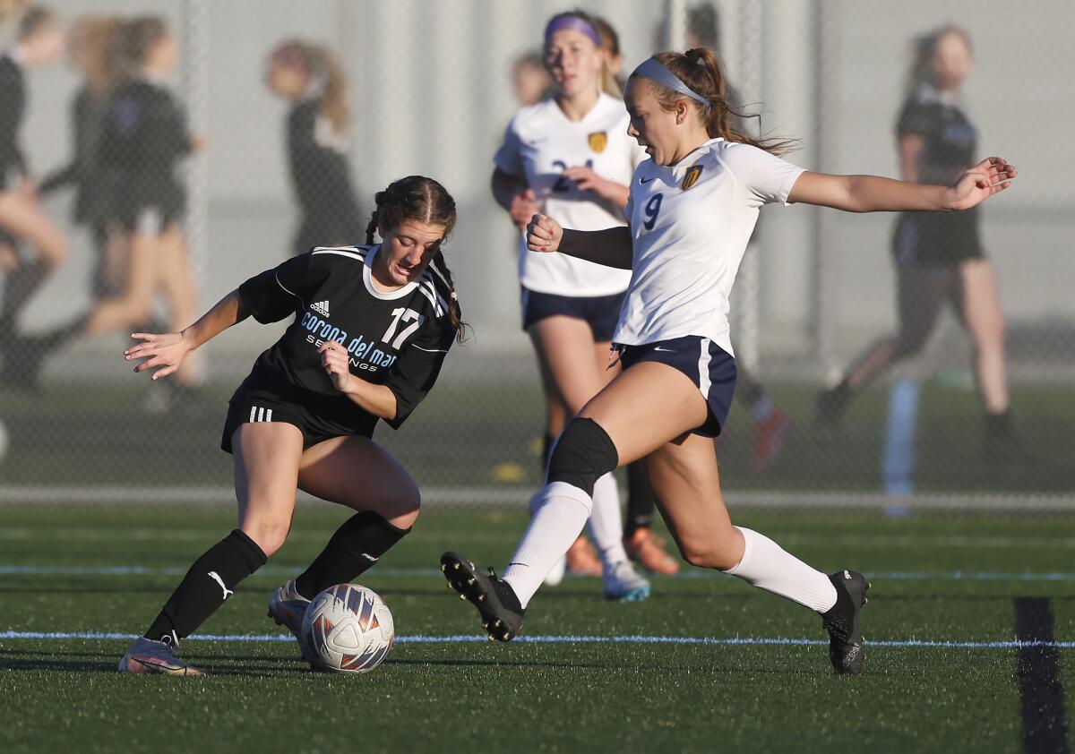 CdM's Isabella Thomas (17) and Marina's Erika Torrez battle for possession during Wednesday's match.