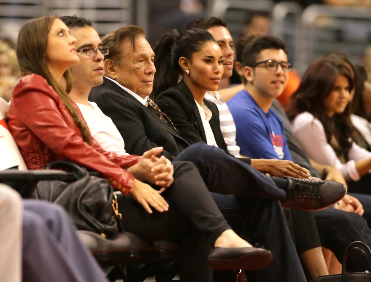 Los Angeles Clippers owner Donald Sterling sits courtside with female friend V. Stiviano during a game against the Utah Jazz at Staples Center.