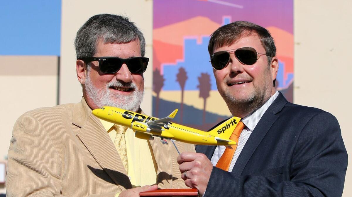 Denis Carvill, deputy executive director of operations at Hollywood Burbank Airport, left, and John Kirby, network planning vice president for Spirit Airlines, right, announced Tuesday that the airline will begin service from the local airfield in June,