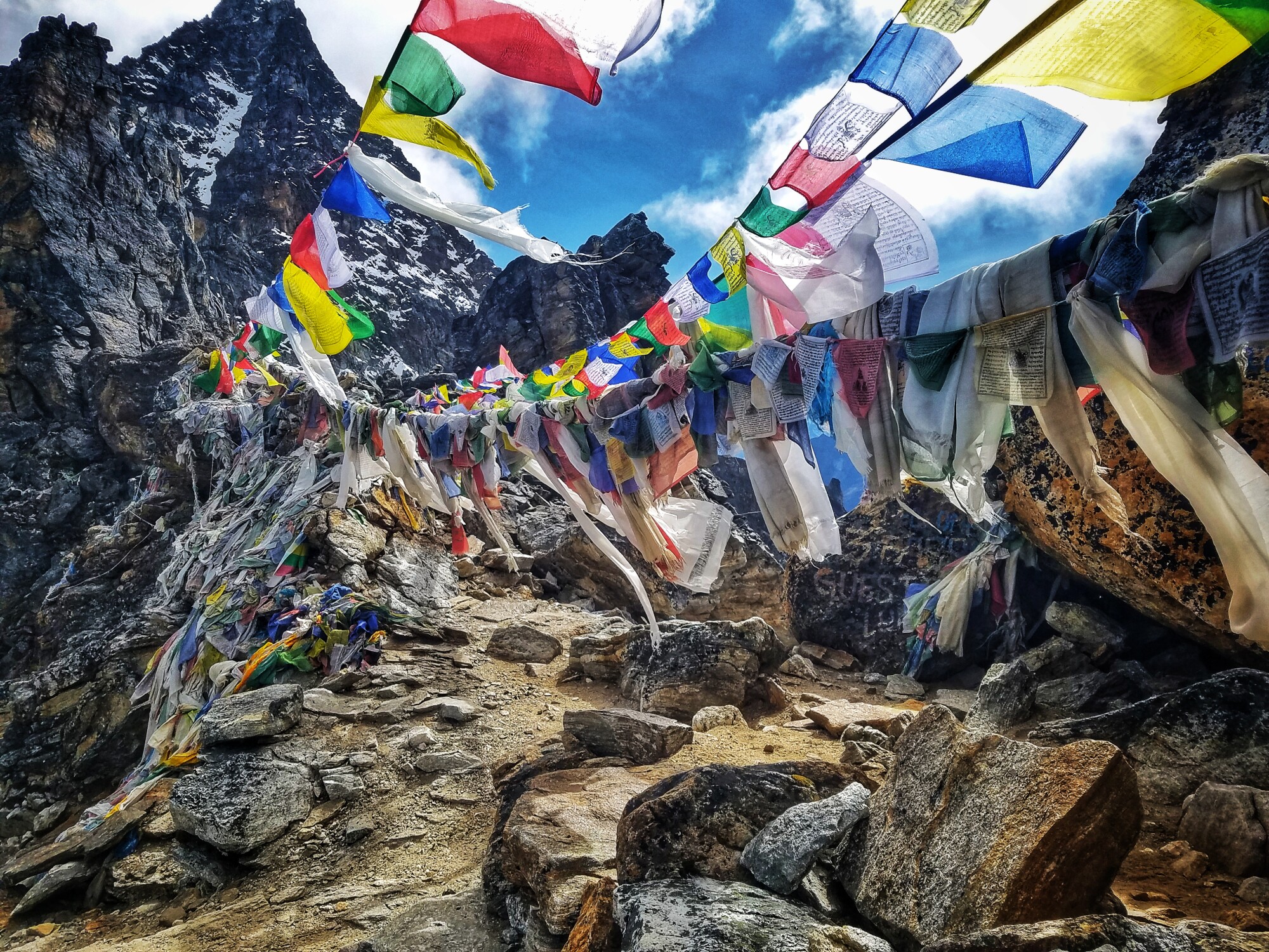 Prayer flags are strung across the summit of Renjo La Pass in the Himalayas.