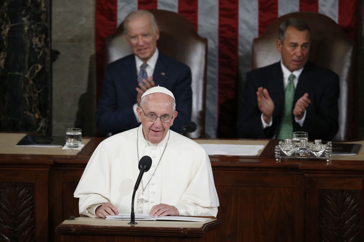 Pope Francis addresses a joint meeting of Congress in 2015, with then-Vice President Joe Biden behind him.