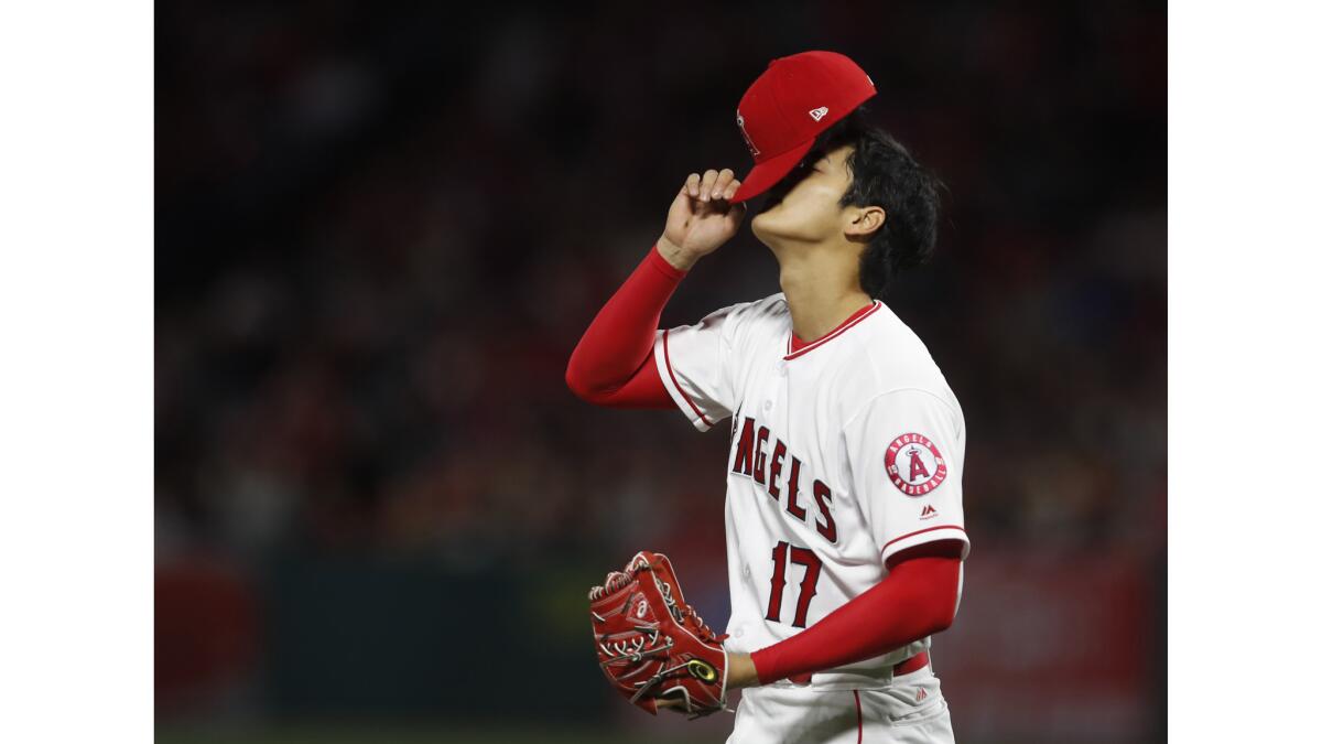 Angels starting pitcher Shohei Ohtani reacts during the second inning of a game against the Red Sox on Tuesday at Angel Stadium. Ohtani gave up three runs in two innings and did not return in the third.