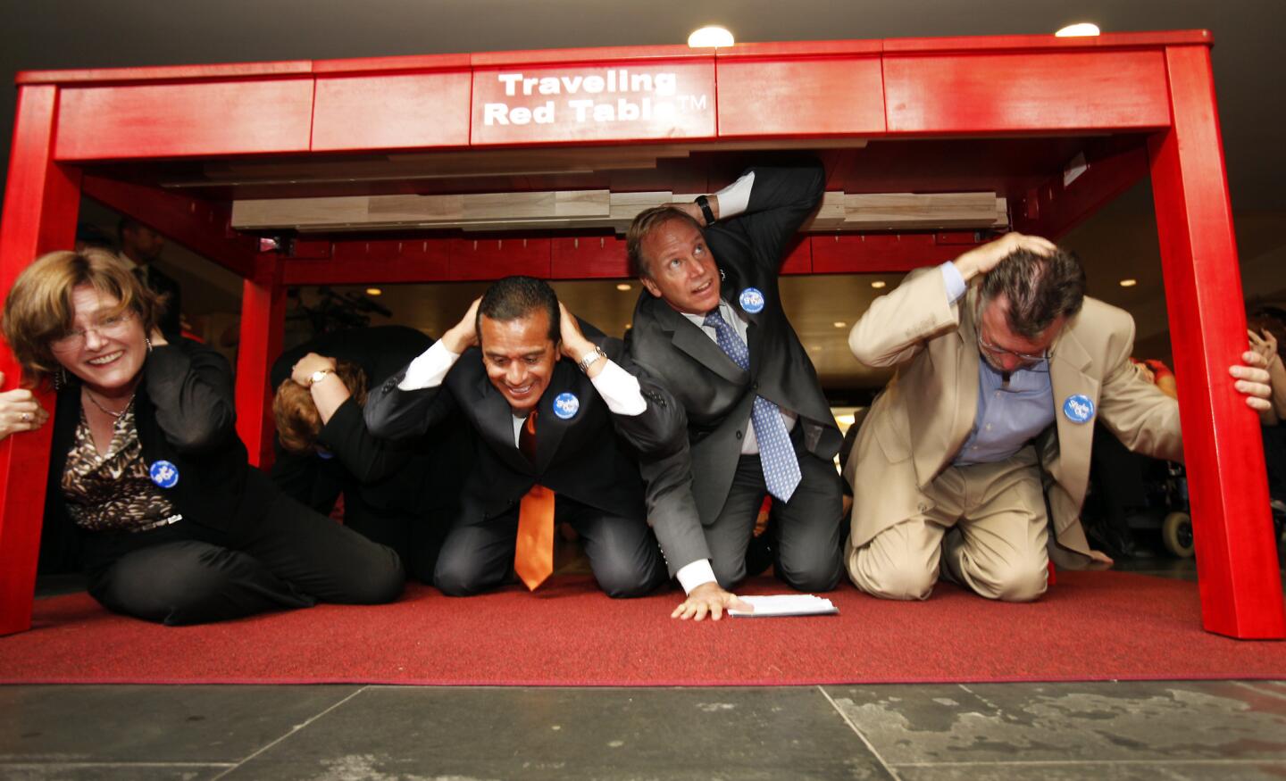 LucyJones joins then-Los Angeles Mayor Antonio Villaraigosa, Paul Schulz of the American Red Cross and Richard Katz of the Metropolitan Transit Authoriity for a 'drop, cover and hold on' drill at Union Station in2012.