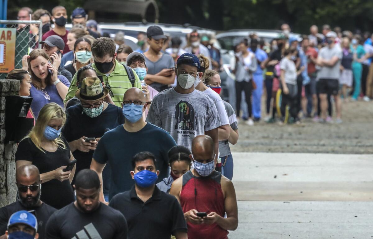 People stand in line to vote. 