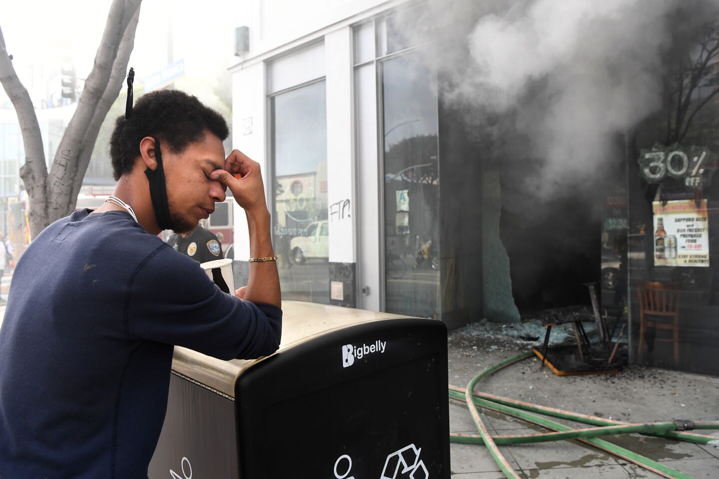 Sake House employee Jared Settles can't bear to watch as the restaurant burns.