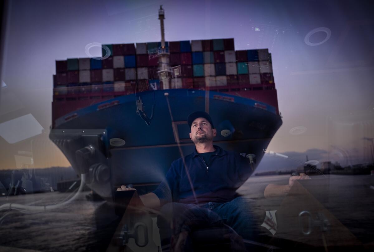 Capt. Mike Johnson reflected in the wheelhouse of the tugboat in Port of Long Beach, CA. 