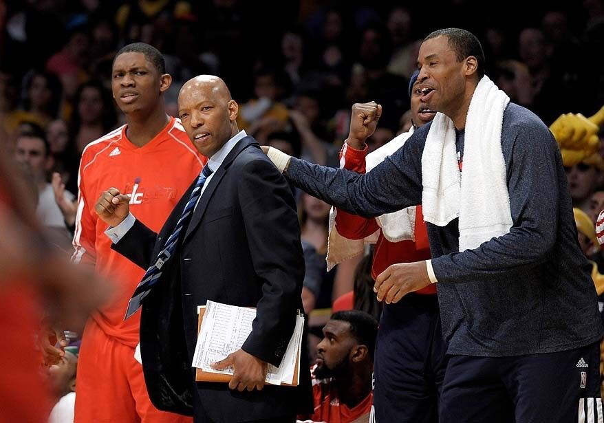 The Washington Wizards' Kevin Seraphin, left, assistant coach Sam Cassell and Jason Collins celebrate the Wizards' victory over the Lakers at Staples Center.
