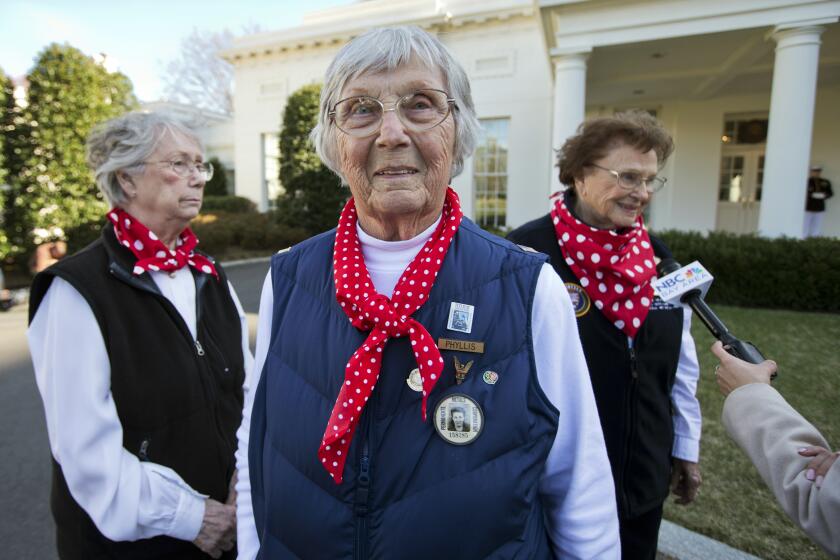 FILE - In this Monday, March 31, 2014, file photo, "Rosie the Riveter" Phyllis Gould, 92, center, her sister Mary Ann Sousa, left, and Agnes Moore, 94, walk on the White House grounds in Washington. Gould, one of the millions of women who worked in defense plants in World War II and who later relentlessly fought to honor those “Rosie the Riverters,” died on July 20, 2021, from complications of a stroke, the San Francisco Chronicle reported. (AP Photo/Manuel Balce Ceneta, File)