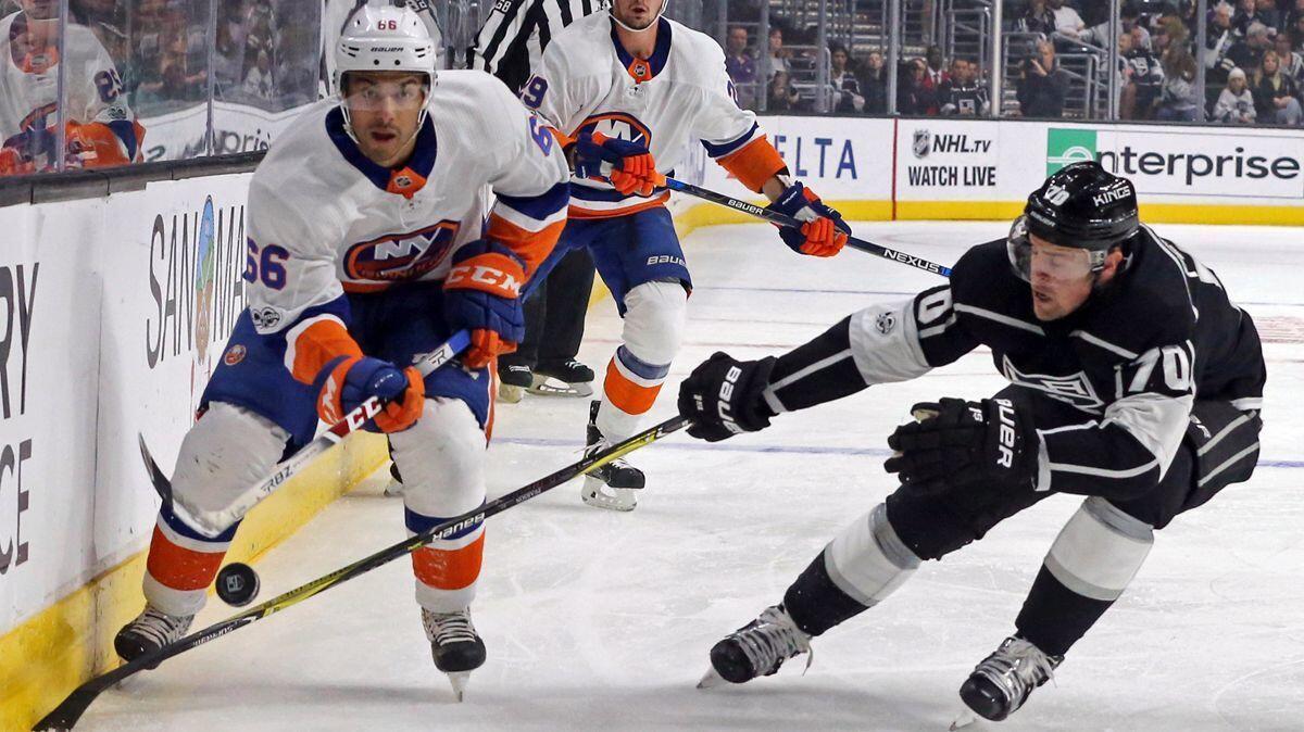 New York Islanders right winger Joshua Ho-Sang (66) and Kings left winger Tanner Pearson (70) battle in the first period on Sunday.