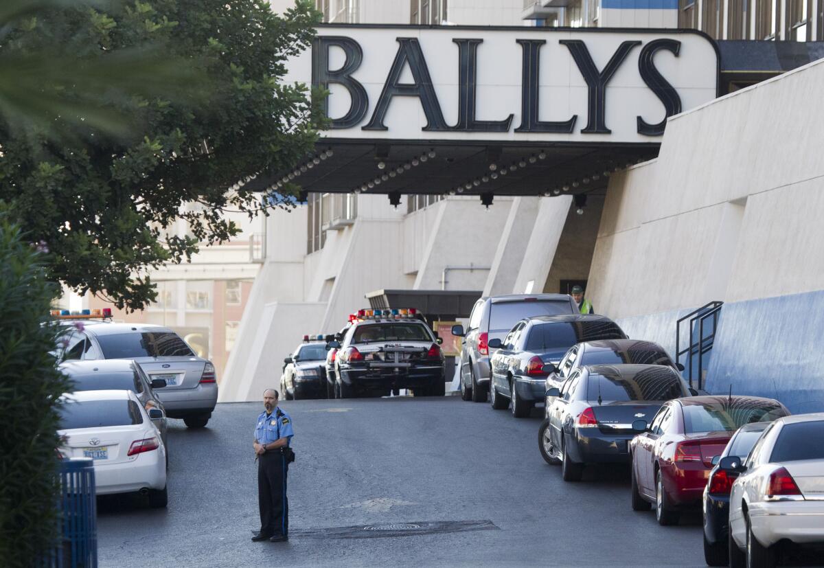 Las Vegas Metro Police cars and a hotel security officer are stationed in front of Bally's hotel casino after an early morning shooting left one person dead and two wounded at Drai's, a nightclub inside Bally's. A suspect is in custody, police said.