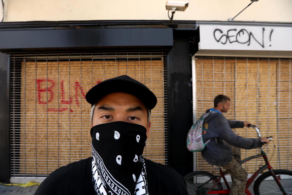Bobby Kim, co-owner of the Hundreds, in front of the boarded-up establishment in the Fairfax District on June 3.
