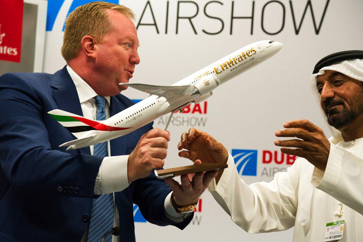 Boeing executive Stanley A. Deal hands a model Boeing 787 Dreamliner to Emirates chief Sheikh Ahmed bin Saeed Al Maktoum