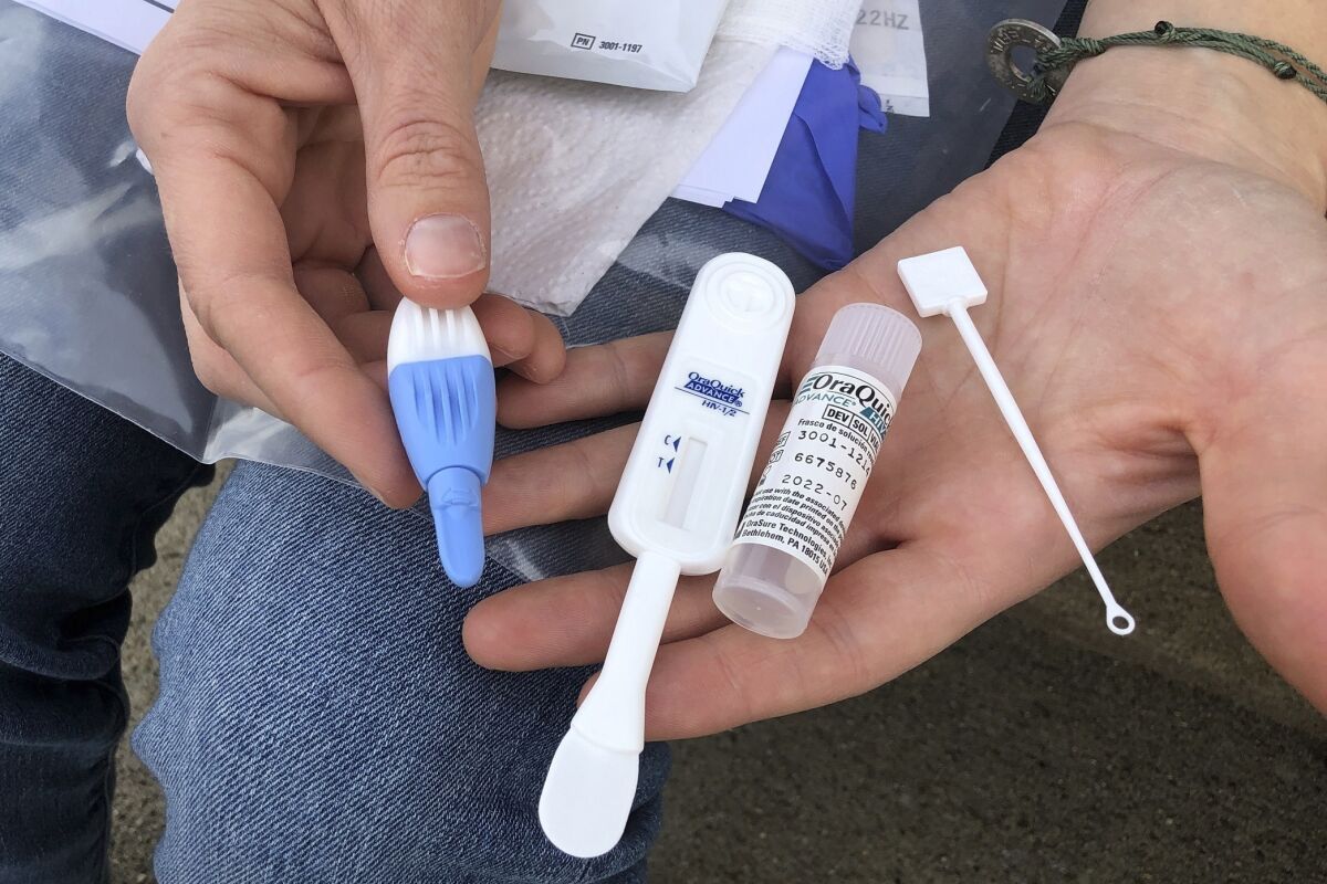 Brooke Parker, an organizer with Solutions Oriented Addiction Response, holds an HIV testing kit. 