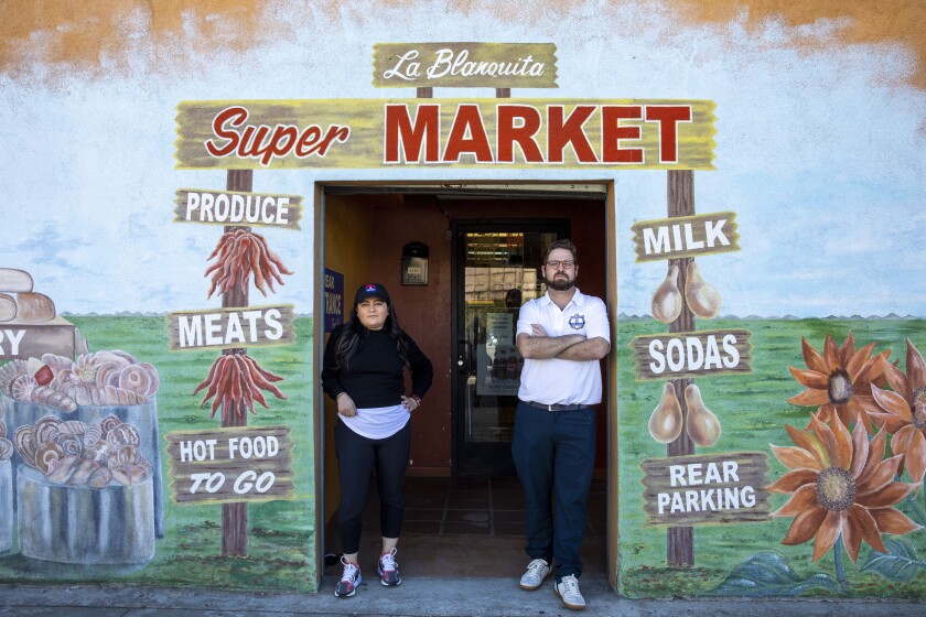 Monica Ramirez, president of La Blanquita, and CEO Enrique Rodriguez, stand at the entrance of their business