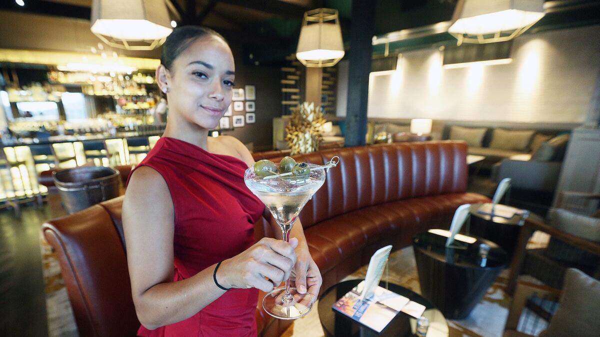 Rayshelle Wright, of Burbank, holds a Classic Martini at Castaway in Burbank in the new hidden cocktail lounge the Green Room on Nov. 1.