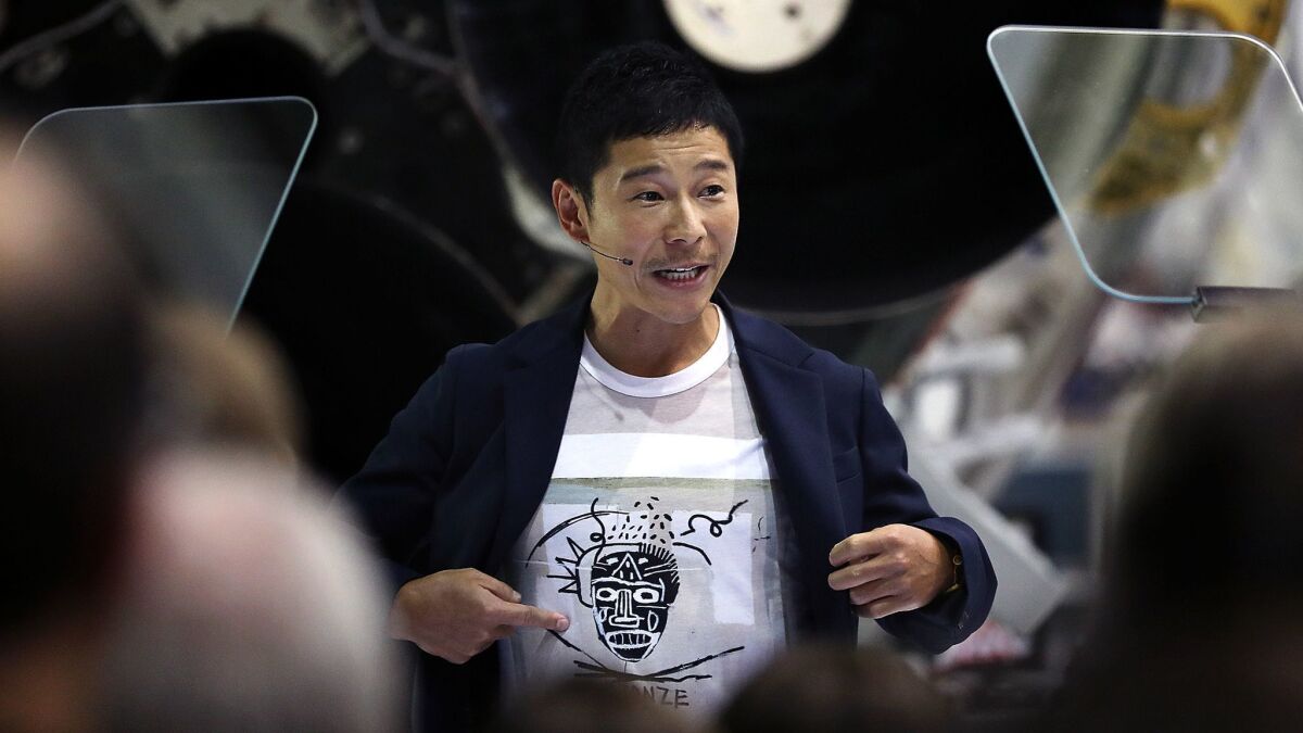 Japanese entrepreneur Yusaku Maezawa speaks at SpaceX in Hawthorne in September, when he was announced as the first paying passenger for an around the moon trip on the company's BFR rocket.