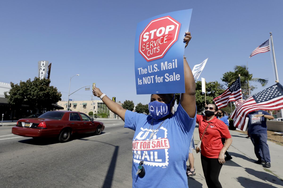 Postal workers rally in front of the Beverly Boulevard Bicentennial Station Post Office in Los Angeles