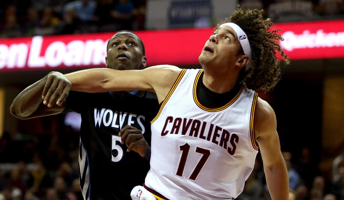 Cavaliers center Anderson Varejao, battling for rebounding position against Timberwolves center Gorgui Dieng, is out for the rest of this season after tearing his left Achilles' tendon in the game against Minnesota on Tuesday.