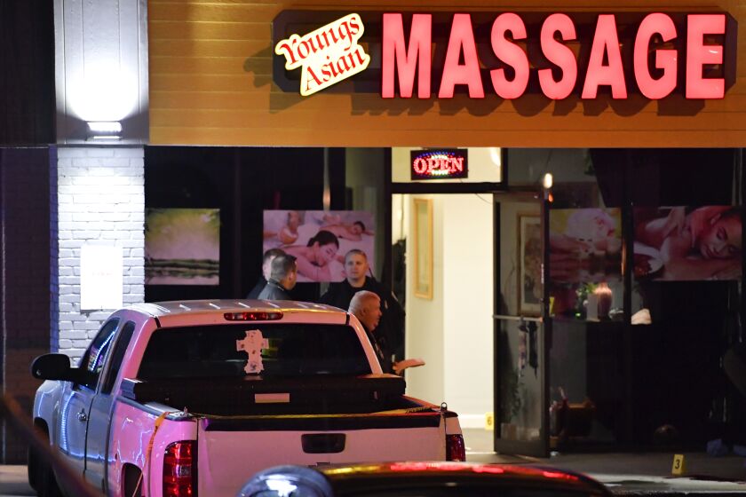 Authorities investigate a fatal shooting at a massage parlor, late Tuesday, March 16, 2021, in Woodstock, Ga. Officials say 21-year-old Robert Aaron Long, of Woodstock, Georgia, has been captured hours after multiple people were killed in shootings at three Atlanta-area massage parlors. (AP Photo/Mike Stewart)