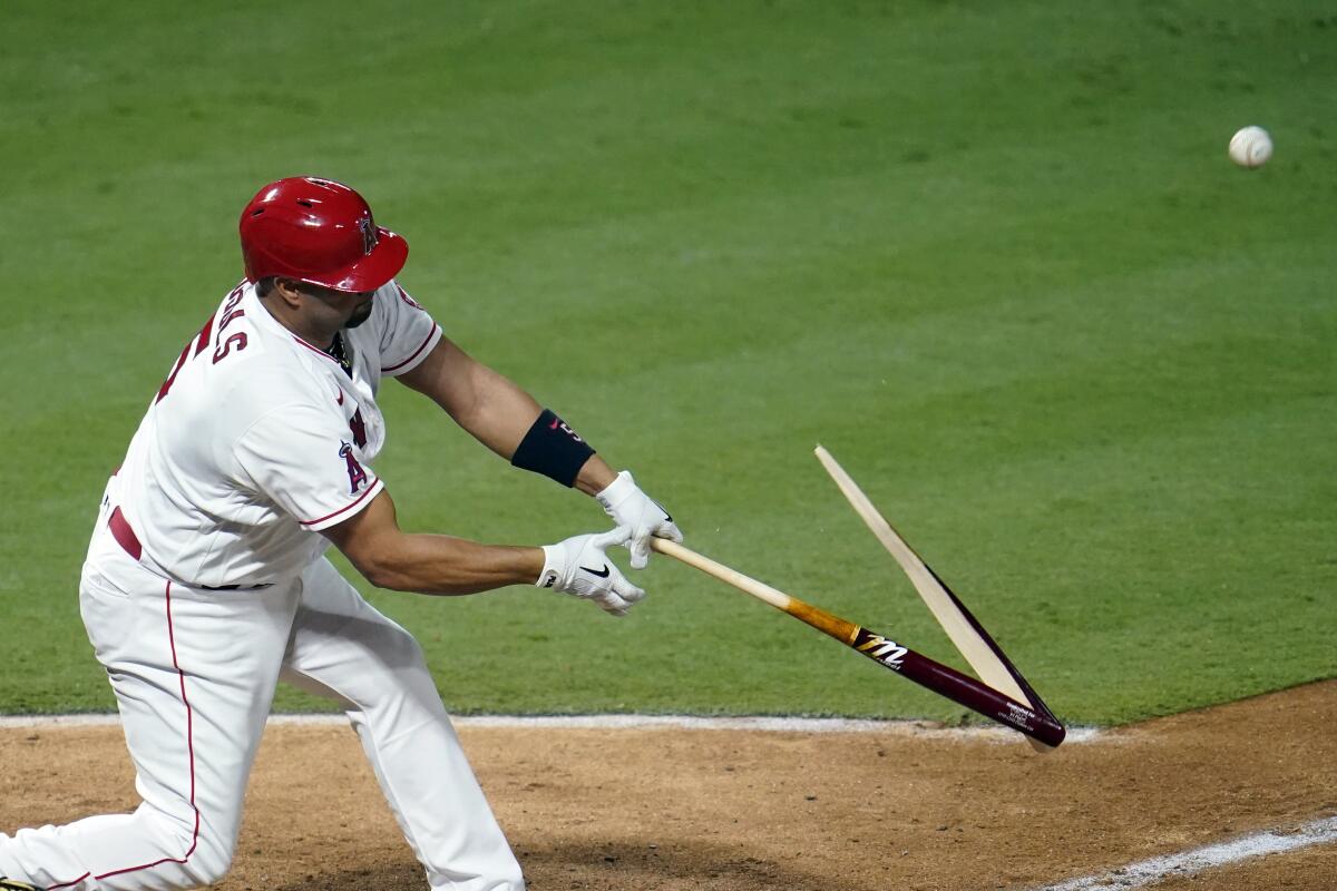 Albert Pujols breaks his bat as he pops out during the third inning of a game against the Diamondbacks.