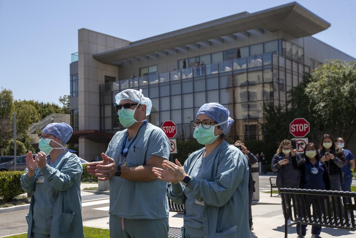 UC Irvine Medical Center healthcare workers return their gratitude as about 25 Orange County first responders' vehicles participate in a drive-by parade of thanks.