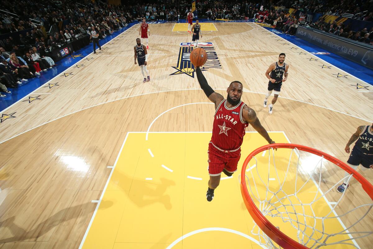 Lakers star LeBron James dunks during the first half of the NBA All-Star Game on Sunday.