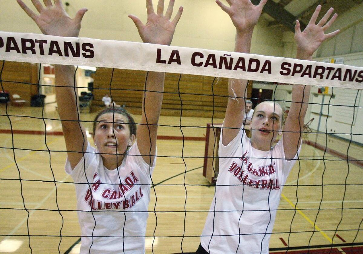 La Cañada High's Megan Reilly, left, and Haley Miller practice their blocking during a practice.