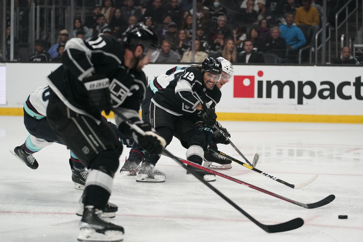 Kings forward Alex Iafallo passes to forward Anze Kopitar to set up a goal by Kopitar against the Kraken.