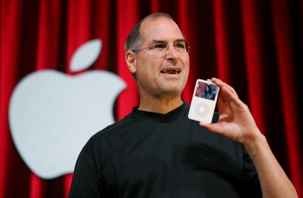 In this 2005 photo, Apple CEO Steve Jobs holds an iPod during an event in San Jose.