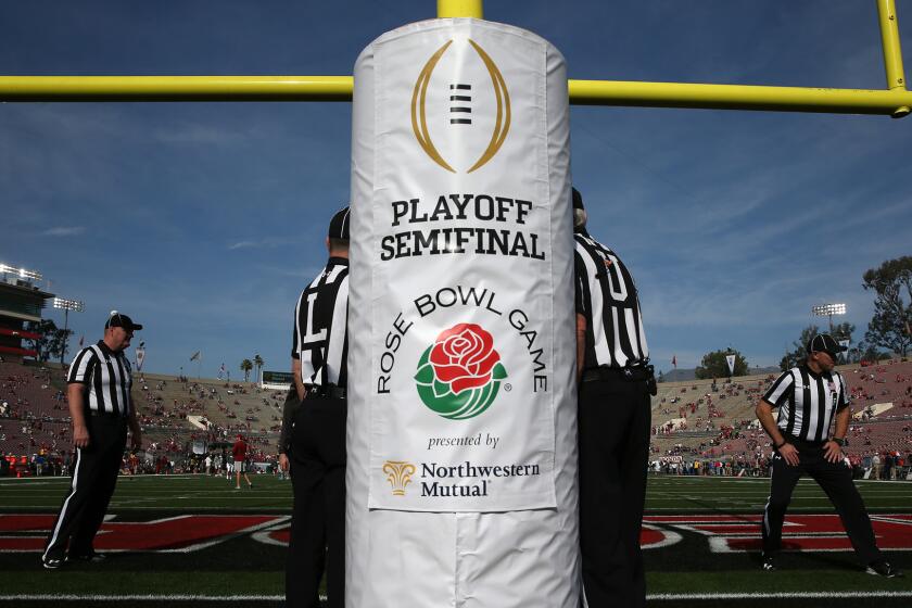 Referees prepare for the Rose Bowl game.