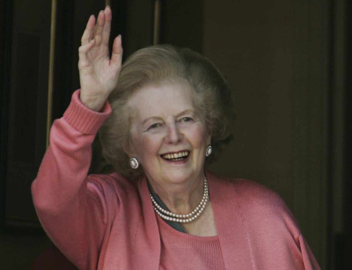 FILE - In this Monday June 29, 2009 file photo, former British Prime Minister Margaret Thatcher waves to members of the media following her return home from hospital suffering from a broken arm, in central London. British Prime Minister Boris Johnson may have survived a no-confidence vote, but his grip on power is far from secure. Many compare his position to that of his predecessor Theresa May, who won a similar vote by a larger margin than Johnson but was nonetheless ousted six months later. Further back in time, Margaret Thatcher survived a first leadership challenge in 1989, but a second one the next year spelled her downfall. (AP Photo/Lefteris Pitarakis, File)